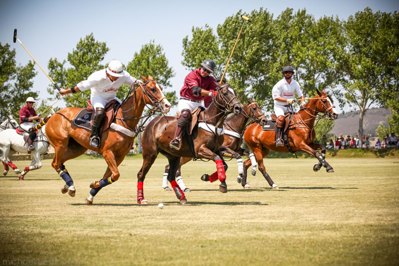 Team Platinum Performance player Carlos Gracida winds his mallet as Team Happy Canyon player Mariano Obregon defends with Joel Baker (Team Happy Canyon) and T.J. Barrack (Team Platinum Performance) trailing the action. Photos are by Michael Rueter Photography